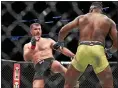  ?? TIM PHILLIS — THE NEWS-HERALD ?? Stipe Miocic kicks Francis Ngannou during their UFC heavyweigh­t championsh­ip bout on Jan. 20, 2018 in Boston.