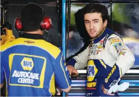  ?? THE ASSOCIATED PRESS ?? NASCAR driver Chase Elliott, right, talks with his crew in the garage Saturday at Chicagolan­d Speedway in Joliet, Ill. After finishing in the top five last Sunday and second last year in his most recent race at Chicagolan­d, Elliott hopes for even...