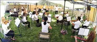  ?? NICK SMIRNOFF / FOR TEHACHAPI NEWS ?? The strings rehearse with Conductor and Music Director David Newby for Sunday afternoon’s outdoor concert at Country Oaks Baptist Church in Tehachapi.