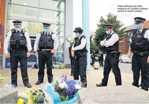  ??  ?? Police officers pay their respects at Croydon custody centre in south London