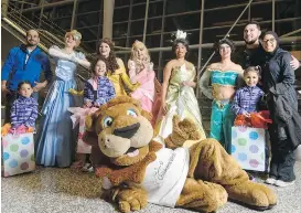  ?? PIER MORENO SILVESTRI/ POSTMEDIA NETWORK ?? Lilyana El-Hajjar, 9, stands behind Roary the Lion, and is surrounded by Disney princesses and family members, after her wish to go to Walt Disney World was granted in Calgary on Tuesday. Lilyana was diagnosed with acute lymphoblas­tic leukemia at the...