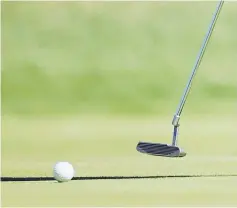  ??  ?? File photo shows a golfer putts on the green. — AFP photo