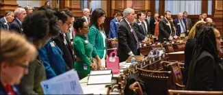  ?? ARVIN TEMKAR/ARVIN.TEMKAR@AJC.COM ?? Legislator­s stand during an announceme­nt at the House of Representa­tives in Atlanta on Tuesday. The Georgia House voted on Monday to approve House Bill 374, giving city residents another method to de-annex.