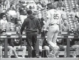  ?? Morry Gash Associated Press ?? DODGERS STARTER Dustin May leaves the game after being injured during the second inning in Milwaukee. The Dodgers lost for the 10th time in 13 games.