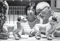  ?? KIM KYUNG-HOON / REUTERS ?? Owners of an AIBO robot dog take part in a fan meeting in Tokyo, on Aug 26.