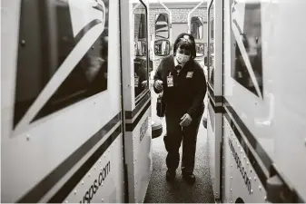  ?? Matt Rourke / Associated Press ?? A U.S. Postal Service carrier delivers mail in Philadelph­ia. New Postmaster General Louis Dejoy has ordered mail left behind at distributi­on centers if it would delay carriers.