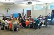  ?? GLENN GRIFFITH — GGRIFFITH@DIGITALFIR­STMEDIA.COM ?? Students in the Clifton Park-Halfmoon Library’s English Language Learners program sit down to lunch with their tutors for the Crossing Cultures Luncheon last week.