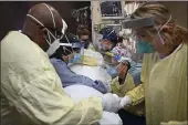  ?? AARON LAVINSKY — STAR TRIBUNE ?? On Monday, critical care nurses and respirator­y therapists flip a patient with COVID-19 upright at North Memorial Health Hospital in Robbinsdal­e, Minn.