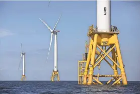  ?? ASSOCIATED PRESS ?? The Deepwater Wind project stand in the Atlantic Ocean off Block Island, R.I. A Danish energy company has pulled out of a billion-dollar project to build wind turbines off the New Jersey coast.