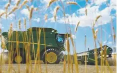  ?? Denver Post file ?? A combine harvests wheat near Wiggins. In each of the past four years, farmers’ share of consumer food spending has dropped sharply.