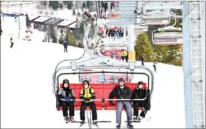  ?? AFP ?? Skiers use chairlifts to access the slopes at Jahorina ski resort, high above Bosnia’s capital Sarajevo.