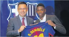  ??  ?? Ousmane Dembele, right, and Barcelona president Josep Maria Bartomeu.