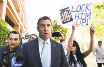  ?? Denis Poroy / Associated Press ?? Southern California Republican Duncan Hunter, leaving a federal court hearing in San Diego, remains in Congress while facing charges that he looted campaign funds for personal use.