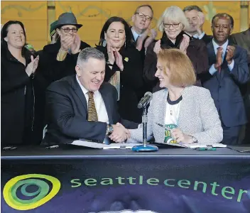  ?? ELAINE THOMPSON/THE ASSOCIATED PRESS ?? Seattle Mayor Jenny Durkan shakes hands with Los Angeles-based Oak View Group CEO Tim Leiweke after they signed an agreement to renovate KeyArena last Wednesday in Seattle. Durkan said that the deal is the best path right now for Seattle to get an NHL...