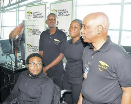  ?? (Photo: Garfield Robinson) ?? Christophe­r Samuda (right), president of the Jamaica Paralympic Associatio­n, speaks to para-athletes Kerona Salmon (second right), Theodore Thomas (third right), and Acee Green at the rededicati­on of the Paralympic Flame at the Norman Manley Internatio­nal Airport in Kingston on March 11, 2024.