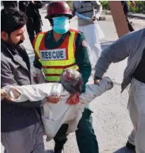  ?? Associated Press ?? Plain clothes police officers carry an injured protester in Islamabad.