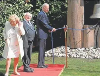  ?? // AFP ?? Biden, junto al presidente Michael D Higgins, toca la Campana de la Paz