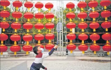  ?? REUTERS ?? A boy plays badminton on a street decorated for Lunar New Year celebratio­ns in Wuhan, Hubei province, China.