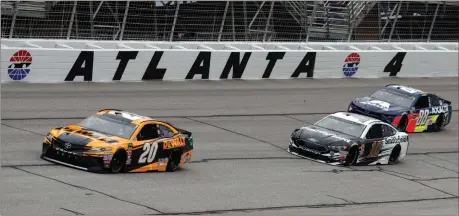  ?? John Bazemore / AP ?? Monster Energy NASCAR Cup Series drivers Erik Jones (20), Aric Almirola (10) and Alex Bowman (88) battle through turn four at Atlanta Motor Speedway.