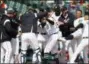  ?? PAUL SANCYA — THE ASSOCIATED PRESS ?? Detroit’s Dixon Machado, center, is congratula­ted for his walk-off solo home run in the ninth inning against the Orioles in Detroit Wednesday.