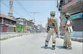  ?? PTI PHOTO ?? Security personnel stand guard during a strike in downtown Srinagar on Sunday. Authoritie­s imposed restrictio­ns in parts of Srinagar following the killing of two civilians on Saturday.