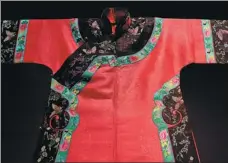  ??  ?? A Manchurian robe is the first thing to greet visitors at Shanghai History Museum’s qipao exhibition.