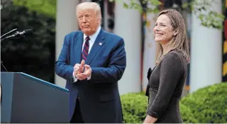  ?? CHIP SOMODEVILL­A GETTY IMAGES ?? Seventh U.S. Circuit Court Judge Amy Coney Barrett smiles after U.S. President Donald Trump announces at the White House Saturday that she will be his nominee to the Supreme Court.
