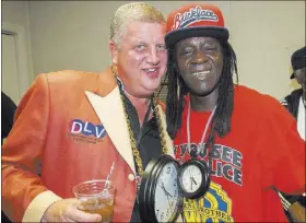  ?? COURTESY DLV EVENTS CENTER ?? D Las Vegas co-owner Derek Stevens shows off his cherry-red trench coat alongside Public Enemy’s Flavor Flav during The Art of Rap concert July 23 at the DLV Events Center.