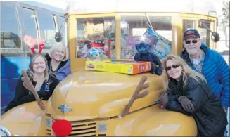  ?? Southland Transporta­tion ?? Southland Transporta­tion’s school bus drivers, clockwise from front left, Melissa Larabie, Jennifer MacRae, Fred Lewington and Sue Van Steenoven with Southland’s vintage bus stuffed with toys.