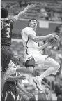  ?? Arkansas Democrat-Gazette/ THOMAS METTHE ?? UALR’s Camron Reedus (11) goes up for a shot while being defended by Texas State’s Deris Duncan (3) during the second half of the Trojans’ 72-70 loss Saturday at the Jack Stephens Center in Little Rock.