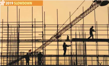  ??  ?? Workers are seen on scaffoldin­g at a constructi­on site in Nantong, Jiangsu province, China. — Reuters