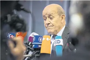  ?? AP ?? French Foreign Minister Jean-Yves Le Drian speaks with the media as he arrives for a meeting of EU foreign ministers at the European Convention Centre in Luxembourg on Monday.