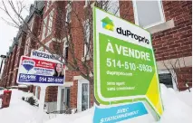  ?? PAUL CHIASSON, THE CANADIAN PRESS FILES ?? For-sale signs are seen in front of a Montreal residentia­l building in this 2015 file photo.