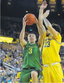  ?? Gregory Shamus, Getty Images ?? Oregon’s Payton Pritchard drives to the basket against Michigan’s Brandon Johns during the second half Saturday at Crisler Arena.