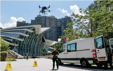  ?? Photo: Yik Yeung-man ?? A drone flies over the high-speed rail terminus as part of a police aero-search operation in West Kowloon yesterday.