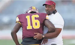  ?? ADAM CAIRNS/COLUMBUS DISPATCH ?? Central State coach Bobby Rome II talks to QB Jacoby Smith at the end of the Classic For Columbus game on Saturday.