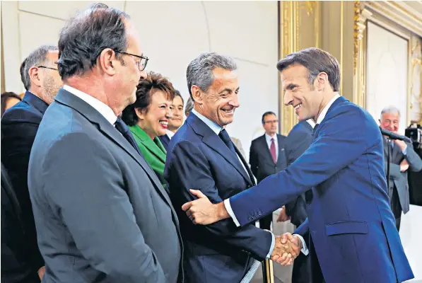  ?? ?? Emmanuel Macron greets his predecesso­rs Nicolas Sarkozy and Francois Hollande as he is sworn in for a second term as president after his re-election, in a ceremony at the Elysee Palace in Paris