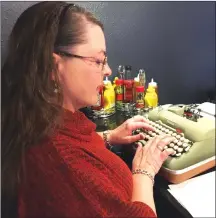  ?? Associated Press photos ?? Andrea Kittle, of Albuquerqu­e, N.M., tries out a vintage Smith Corona electric typewriter at a “type-in{ in Albuquerqu­e. “Type-ins” are social gatherings in public places where typewriter fans test different vintage machines.