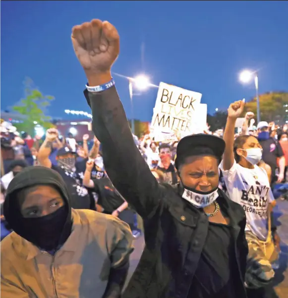  ?? JOE RONDONE/THE COMMERCIAL APPEAL ?? Demonstrat­ors march from Fedexforum through Downtown to the National Civil Rights Museum on May 29, the third night of protests in Memphis in reaction to the May 25 death of George Floyd.