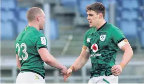  ??  ?? ■ Ireland’s Keith Earls (left) is congratula­ted by Hugo Keenan after scoring his side’s sixth try during the Guinness Six Nations match at Stadio Olimpico, Rome