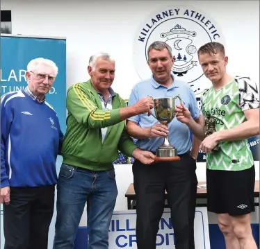  ??  ?? James Cahillane (second from left) presenting the Kieran Cahillane Top Goal Scorer Cup to Chris O’Leary with (left) Don O’Donoghue and Michael O’Shea Chairman at the Killarney Athletic FC/Killarney Credit Union 7 A Side Tournament Premier final at...