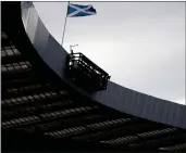  ??  ?? A Saltire flies over Hampden yesterday, and main picture, Leigh Griffiths scores a goal at the stadium. Below, Susan Aitken