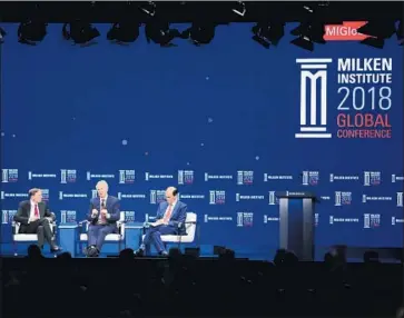  ?? Jae C. Hong Associated Press ?? MICHAEL MILKEN, right, moderating a talk at a Milken Institute conference in April, was indicted on 98 felony charges in 1989 but pleaded guilty to six counts of less serious securities and tax violations.