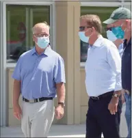  ?? H John Voorhees III / Hearst Connecticu­t Media file photo ?? Gov. Ned Lamont talks with Mark Boughton, then the Danbury mayor, before a press conference in Danbury in 2020. Boughton is now the state tax commission­er.