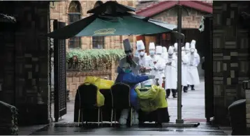  ?? ?? Slashing outlook: Chefs line up for Covid-19 tests at a hotel during a lockdown in Shanghai. SMIC estimates that a month-long lockdown may spur component shortages and logistics tangles as well as erase 5% of its output in the second quarter. — Reuters