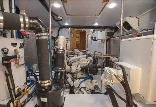  ??  ?? Standing headroom, exceptiona­l ventilatio­n, a salty workbench and beefy handrails in the engine room define the 50 as a long-distance cruiser.