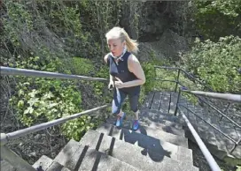  ?? Peter Diana/Post-Gazette ?? Christina French runs up the 18th Street Steps to Pius Street on the South Side Slopes.