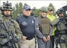  ?? Colombian Presidenti­al Press Office ?? POLICE ESCORT Dairo Antonio Úsuga, in handcuffs, before his extraditio­n to the United States last year. The notorious cartel leader was known as Otoniel.