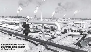  ??  ?? A worker walks at Nahr Bin Umar oilfield north of Basra, Iraq