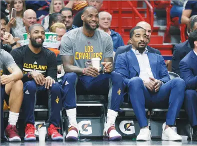  ?? LYNNE SLADKY / AP ?? Cleveland Cavaliers’ Kyrie Irving (left), LeBron James (center) and JR Smith watch from the bench during the first half of an NBA game against the Miami Heat on March 4. Last season, when stars like James, Irving, Stephen Curry and Draymond Green were...